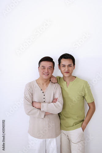 Senior man and man posing together