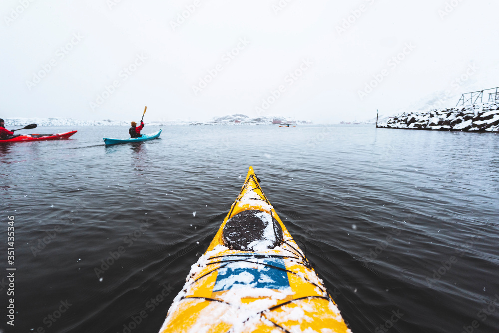 Fototapeta premium Woman paddling the kayak in Lofoten, Norway