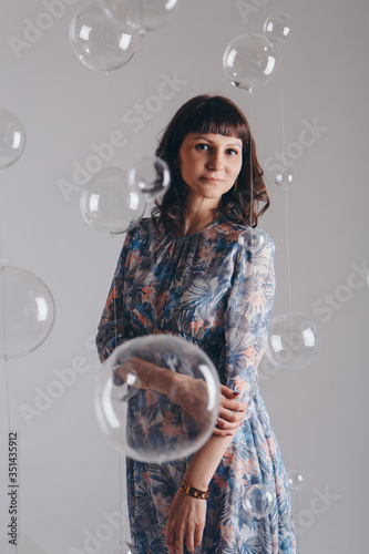 portrait of woman on a white background with glass balls © aaalll3110