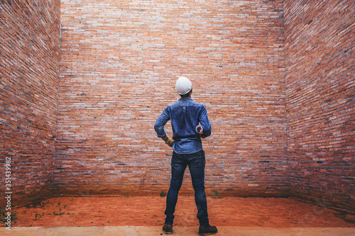 Fotografija Structural engineer with blueprints thinking for problem dead end at the tall wall building structure, Break through the dead end wall concept