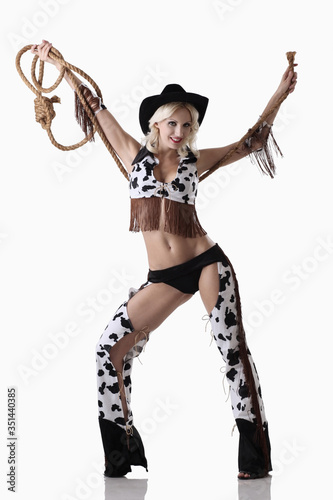 Vászonkép Woman in cowgirl costume holding rope