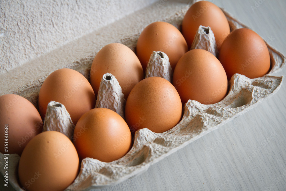 Full tray with chicken eggs. Eggs cardboard container. Close-up. Selective focus Full tray with chicken eggs. Eggs cardboard container. Close-up. Selective focus