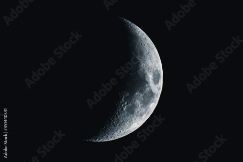 Crescent moon in a black sky photo