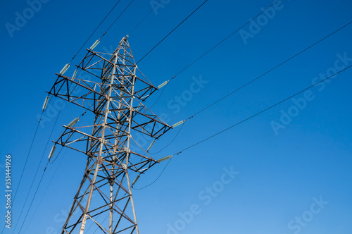 Pylon of an overhead power line (transmission pylon) against a blue sky