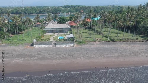 camera fly away from a scythe between a river with boats and the ocean