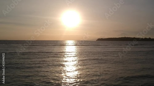 flying low over water at sunset
