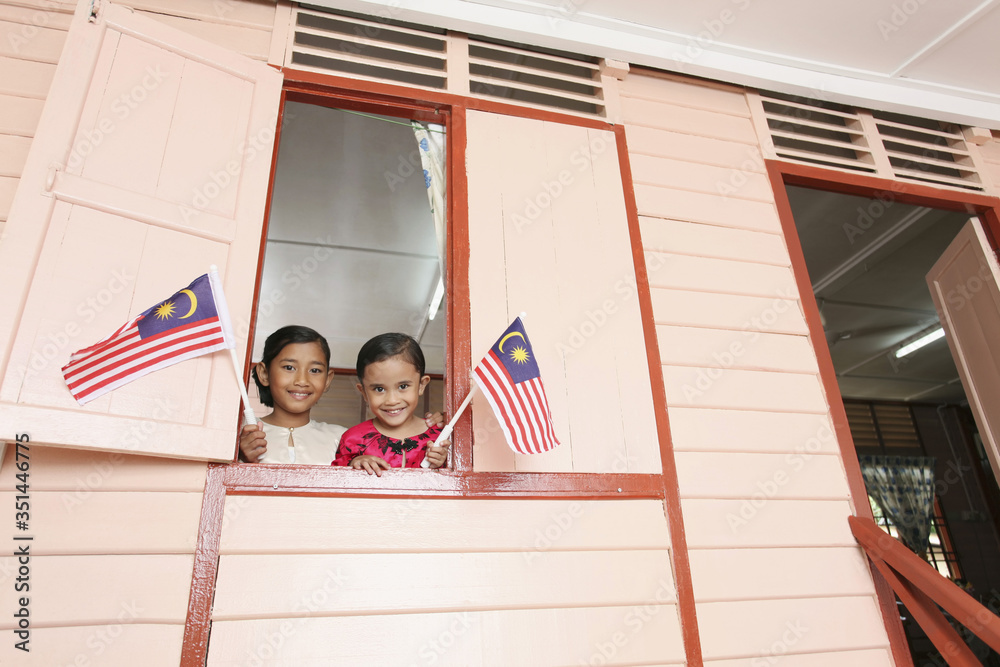 Girls holding flag, smiling Girls holding flag, smiling
