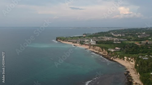 the drone lands down and takes off the ocean with a cliff Bingin Beach Pantai bukit bali indonesia