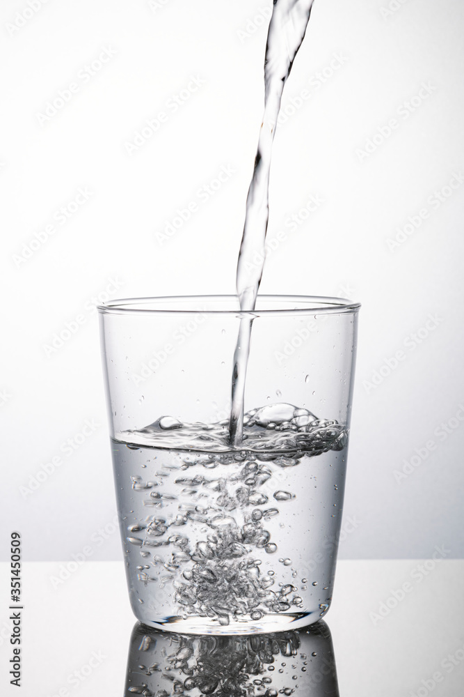 Macro shot of water pouring into a glass Macro shot of water pouring into a glass