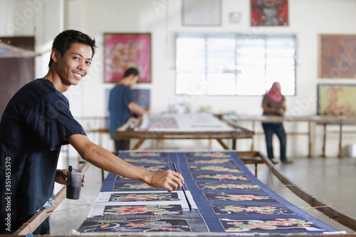 Canvas Print Man painting batik fabric
