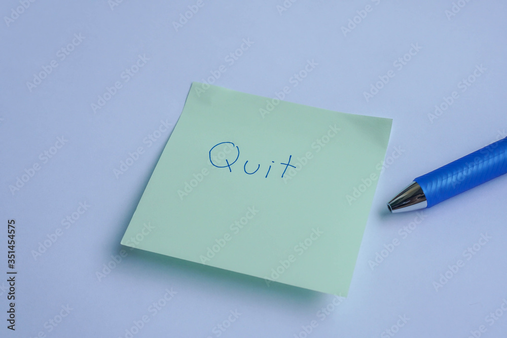 flat lay business concept to quit the job with handwriting on sticky note with pen flat lay business concept to quit the job with handwriting on sticky note with pen