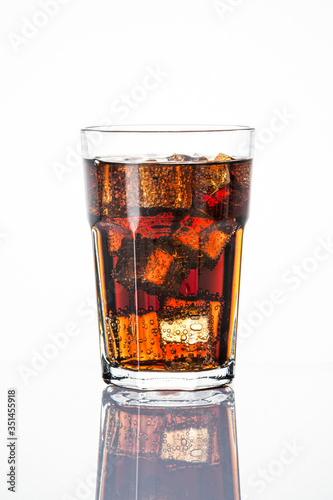 Photography Cold carbonated drink over ice cubes in a  glass