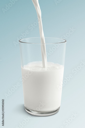 Close up of pouring fresh milk into a glass