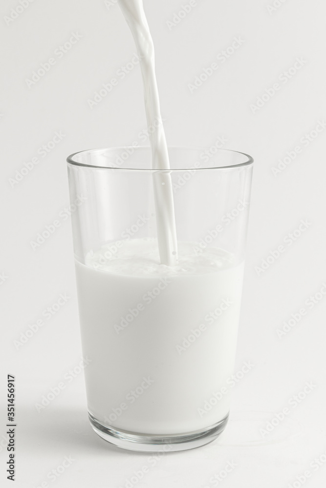 Close up of fresh milk poring into a glass