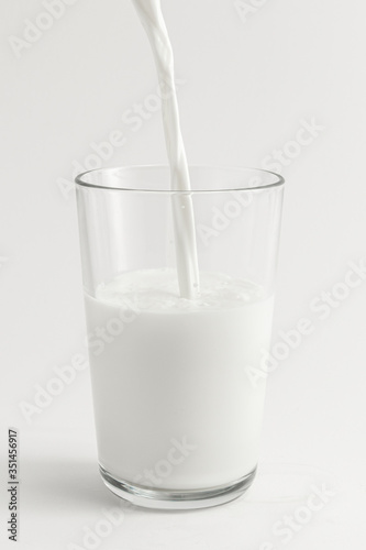 Close up of fresh milk poring into a glass