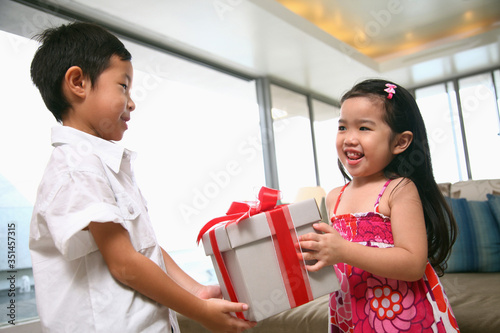 Wallpaper Mural Girl receiving a gift box from boy Torontodigital.ca