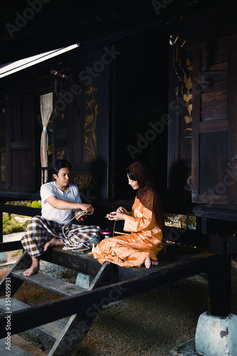 Man and woman repairing tops © ImageHit