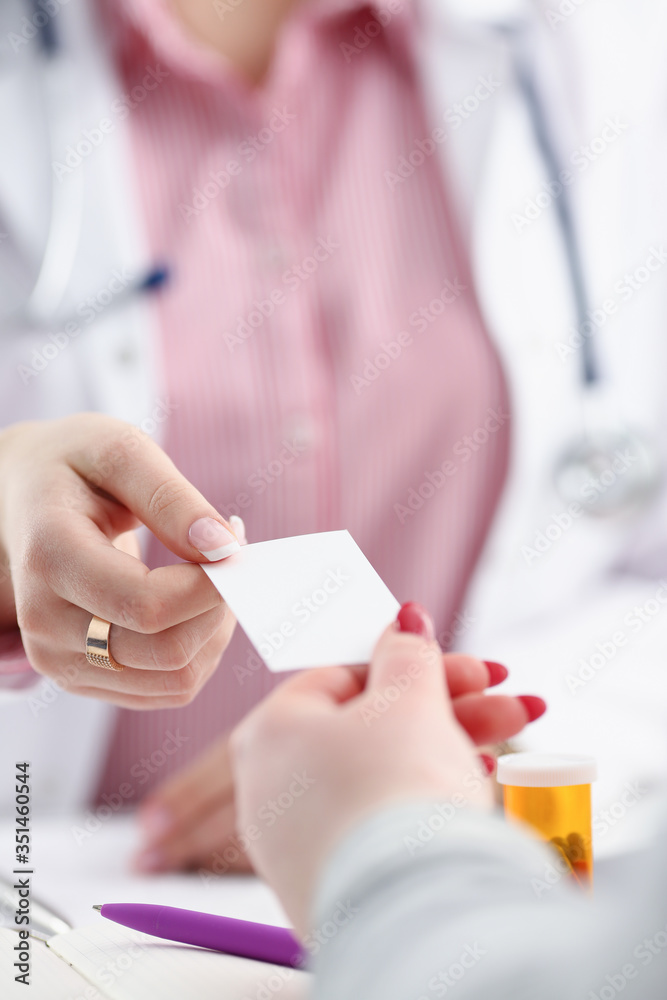 Female physician hand give white blank Female physician hand give white blank