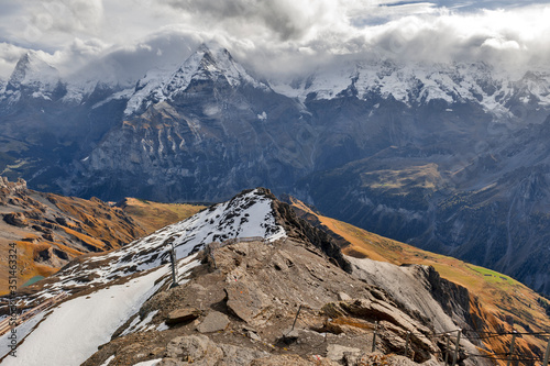 Scenic view of snow-capped mountains of the Swiss Alps skyline seen from the Schilthorn, a summit in the Bernese Alps above the village of Murren in Lauterbrunnen, Switzerland