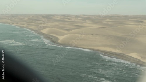 Aerial view of sea against sky seen from airplane, beach at desert area - Sossusvlei, Namibia photo