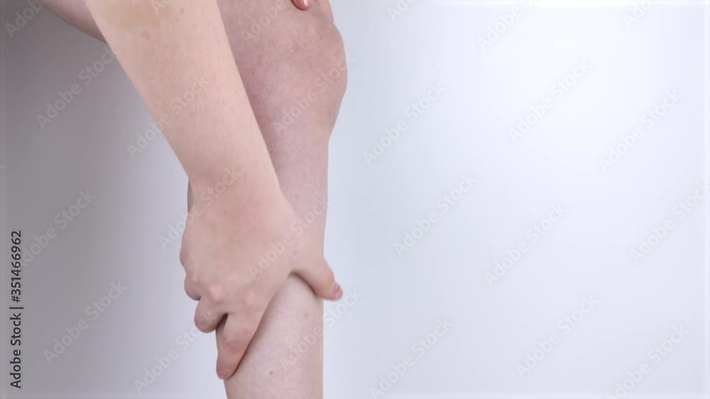 A woman suffers from pain in the calves. Stretching the calf muscle
