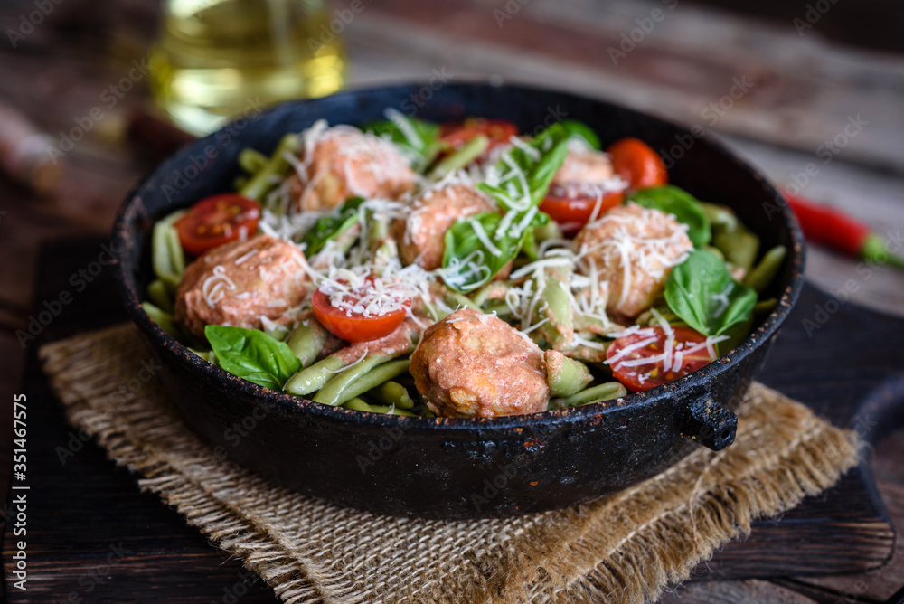 Delicious fresh pasta with meatballs, sauce, cherry tomatoes and basil Delicious fresh pasta with meatballs, sauce, cherry tomatoes and basil