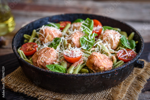 Delicious fresh pasta with meatballs, sauce, cherry tomatoes and basil