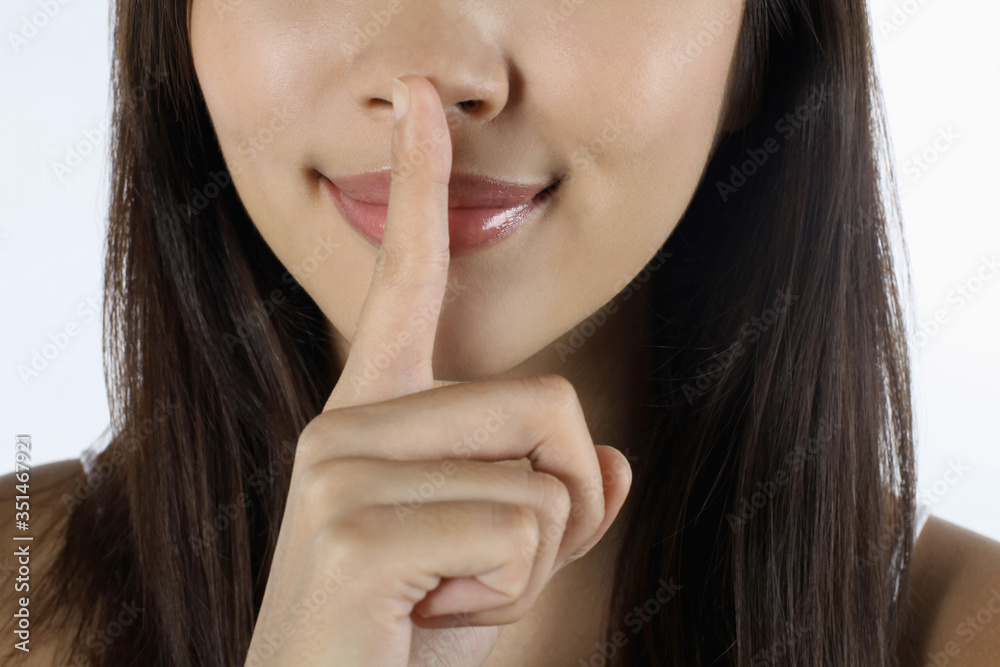 Woman with finger on lips Woman with finger on lips