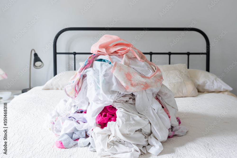 Close up of clean laundry pile on double bed (selective focus) Close up of clean laundry pile on double bed (selective focus)