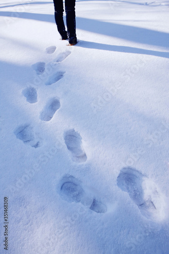 Trail of woman's footprints in snow