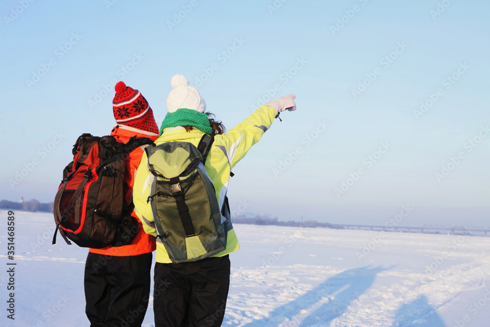 Women with backpacks looking for direction