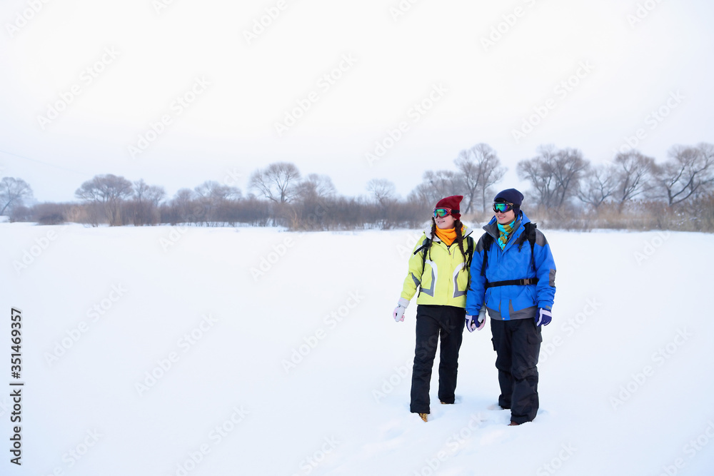 Man and woman in warm clothing and ski goggles