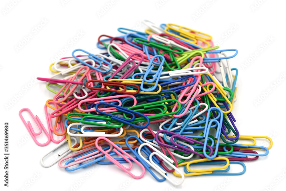 Paper clips isolate on white background.Paper clips is a device used to hold sheets of paper together, usually made of steel wire bent to a looped shape Paper clips isolate on white background.Paper clips is a device used to hold sheets of paper together, usually made of steel wire bent to a looped shape