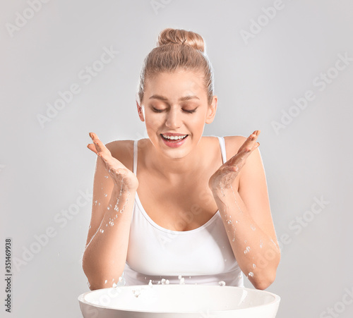 Woman washing face against ...