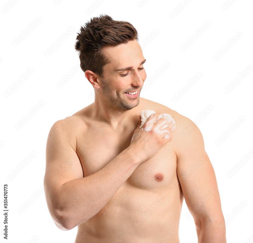 Handsome man taking shower against white background Handsome man taking shower against white background