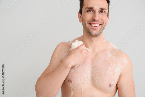 Handsome man taking shower ...