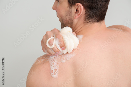 Handsome man taking shower ...