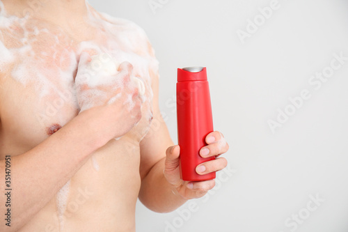 Handsome man with shower ge...