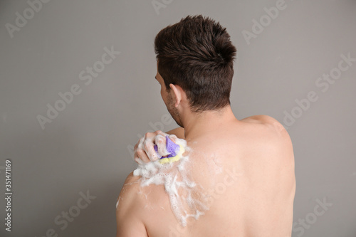 Handsome man taking shower ...