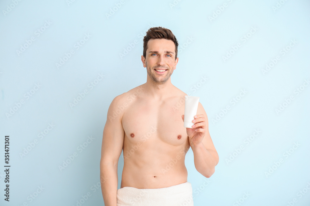Fototapeta premium Handsome man with shower gel on color background