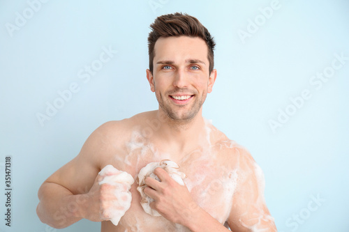 Handsome man taking shower ...