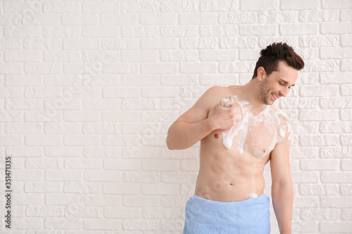 Handsome man taking shower ...