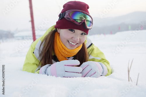 Woman lying forward in snow