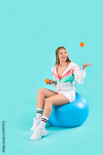 Young woman with tangerines...