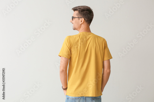 Man in stylish t-shirt on g...
