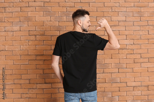 Man in stylish t-shirt near...