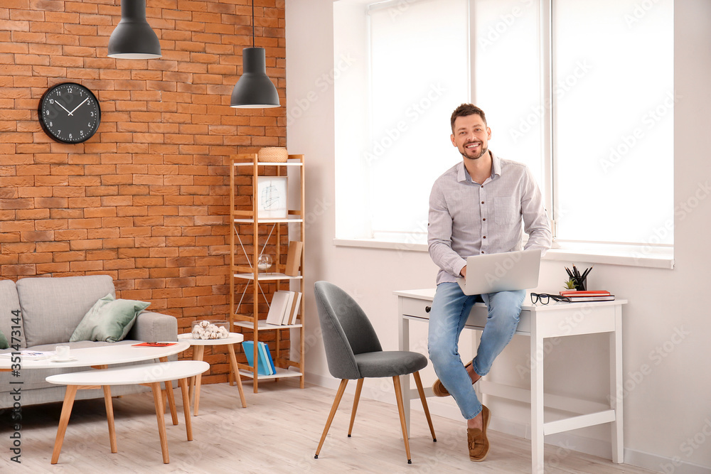 Man with laptop working at home Man with laptop working at home