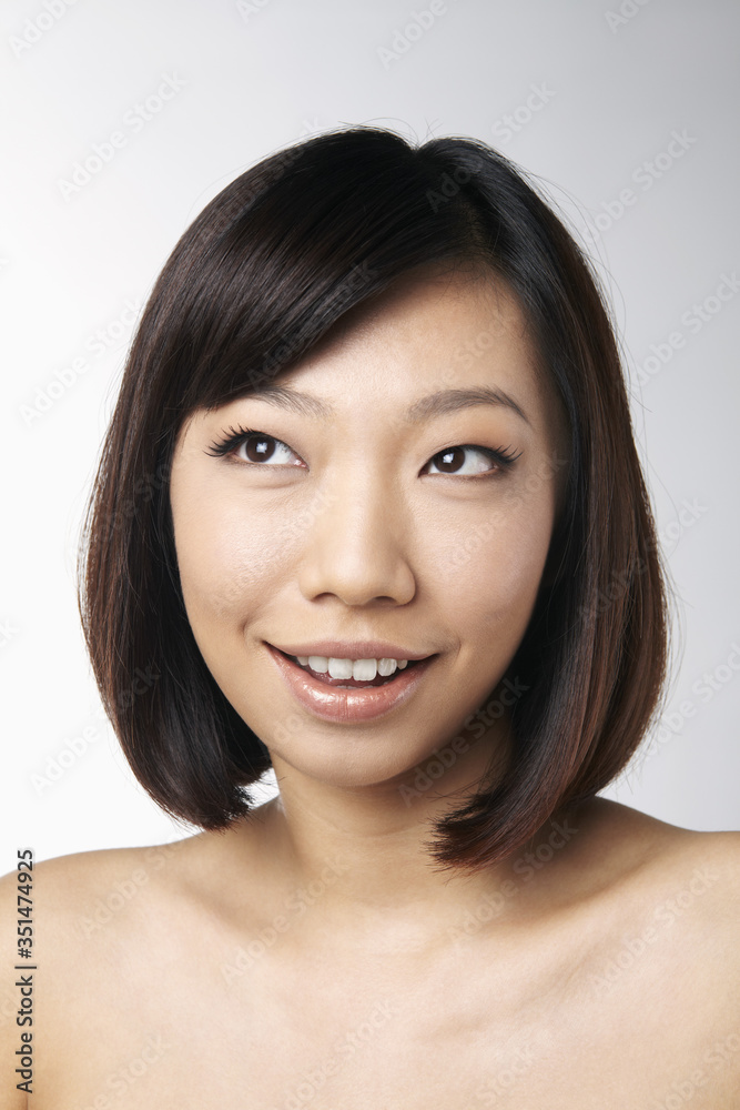 Portrait of woman smiling and looking away Portrait of woman smiling and looking away