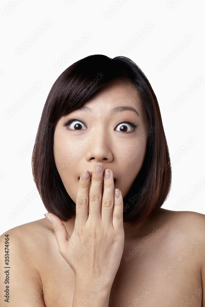 Surprised woman with hand covering her mouth Surprised woman with hand covering her mouth