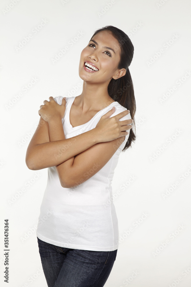 Happy woman hugging herself